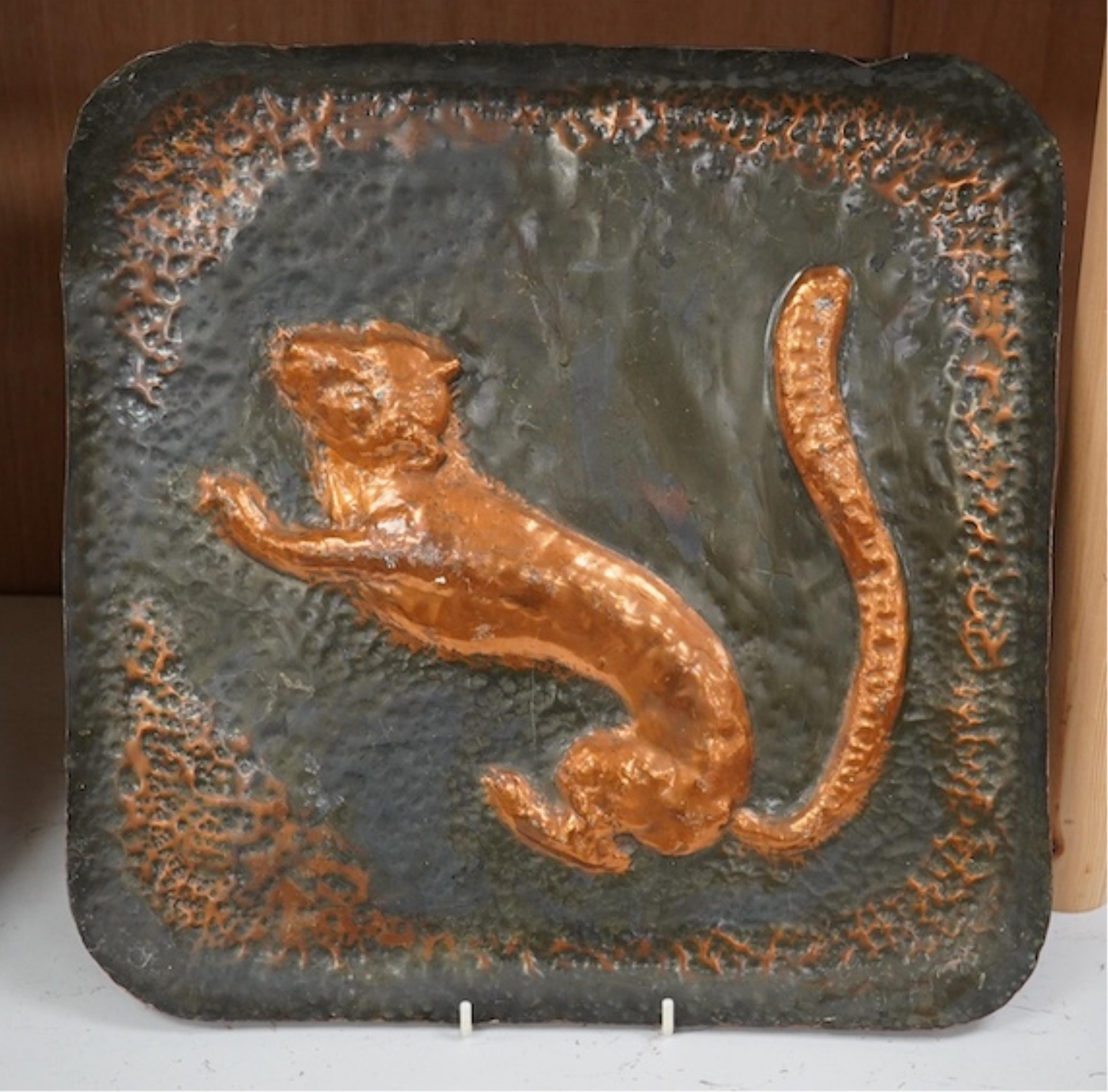 A pair of planished copper trays, one of an Impala and the other a Lion. 39.5cm square. Condition - fair